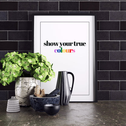 True Colours med färgade bokstäver står lutad mot en kakelvägg