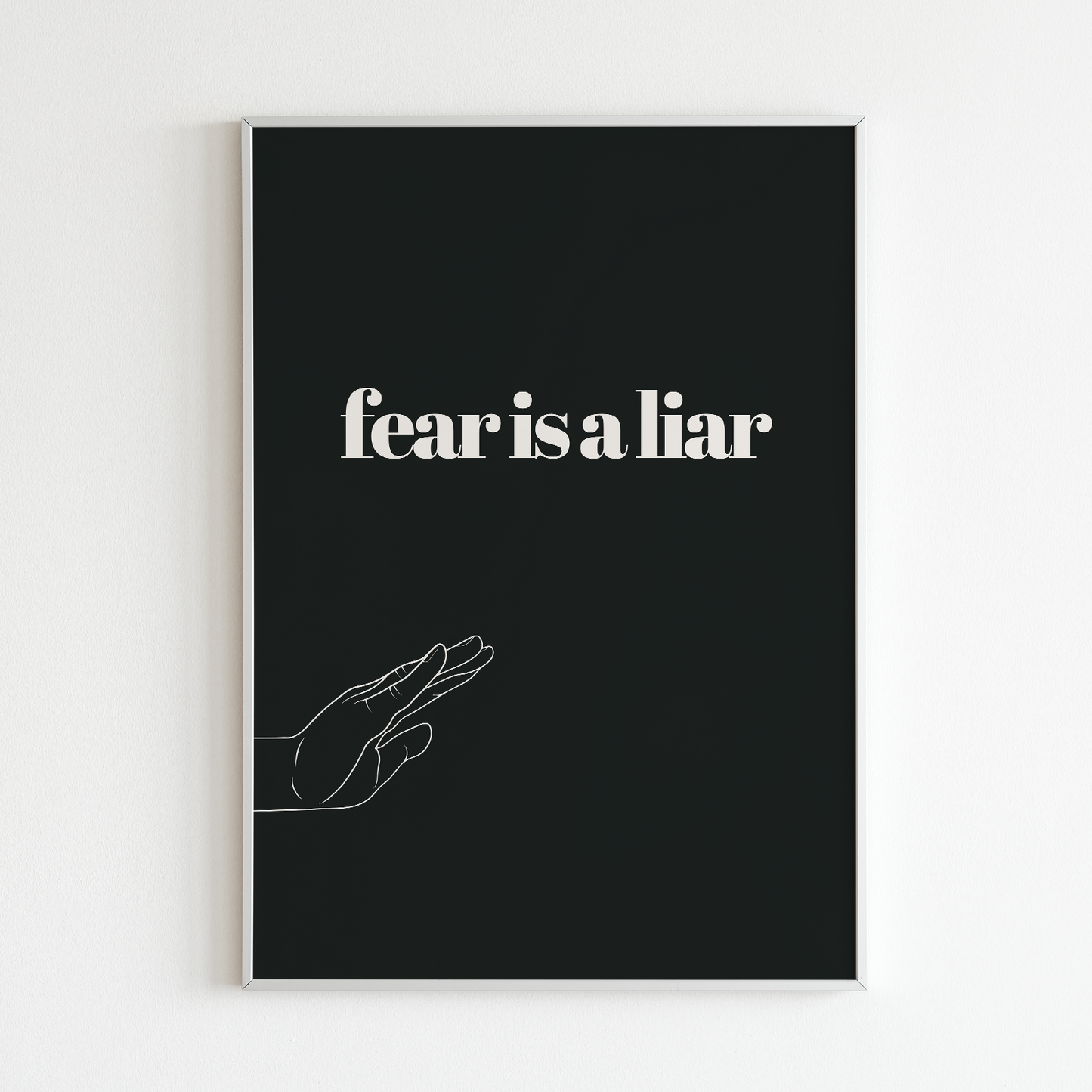 Poster Fear is a liar inramad mot vit vägg
