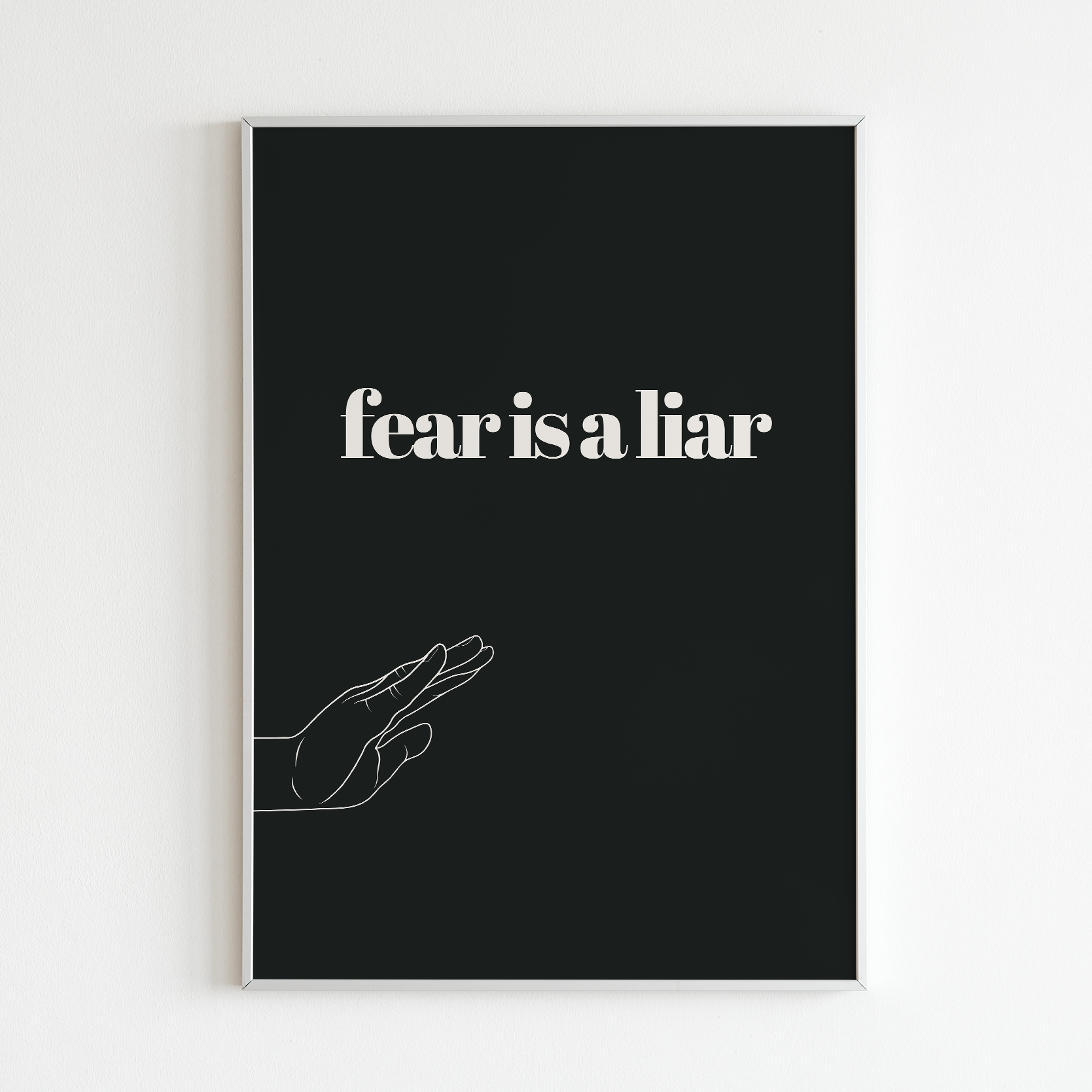 Poster Fear is a liar inramad mot vit vägg