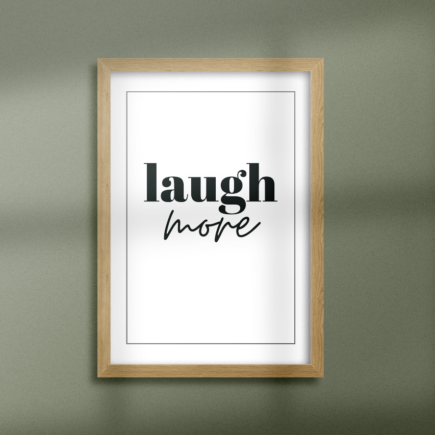 Poster Laugh more inramad mot grön vägg